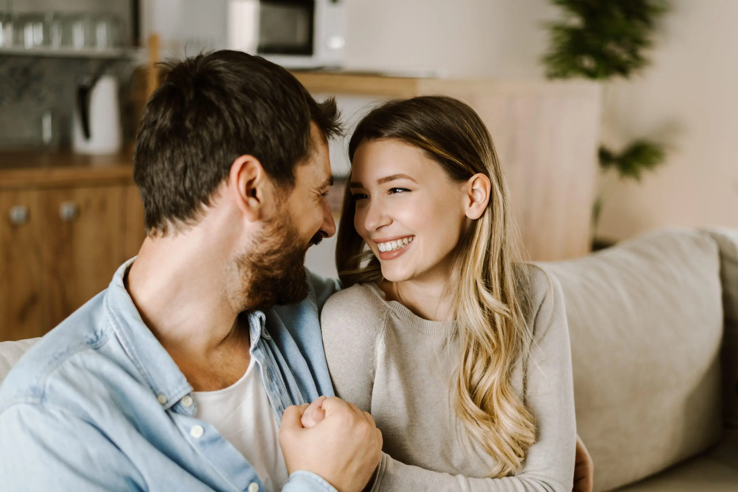 Loving happy couple talking to each other at home