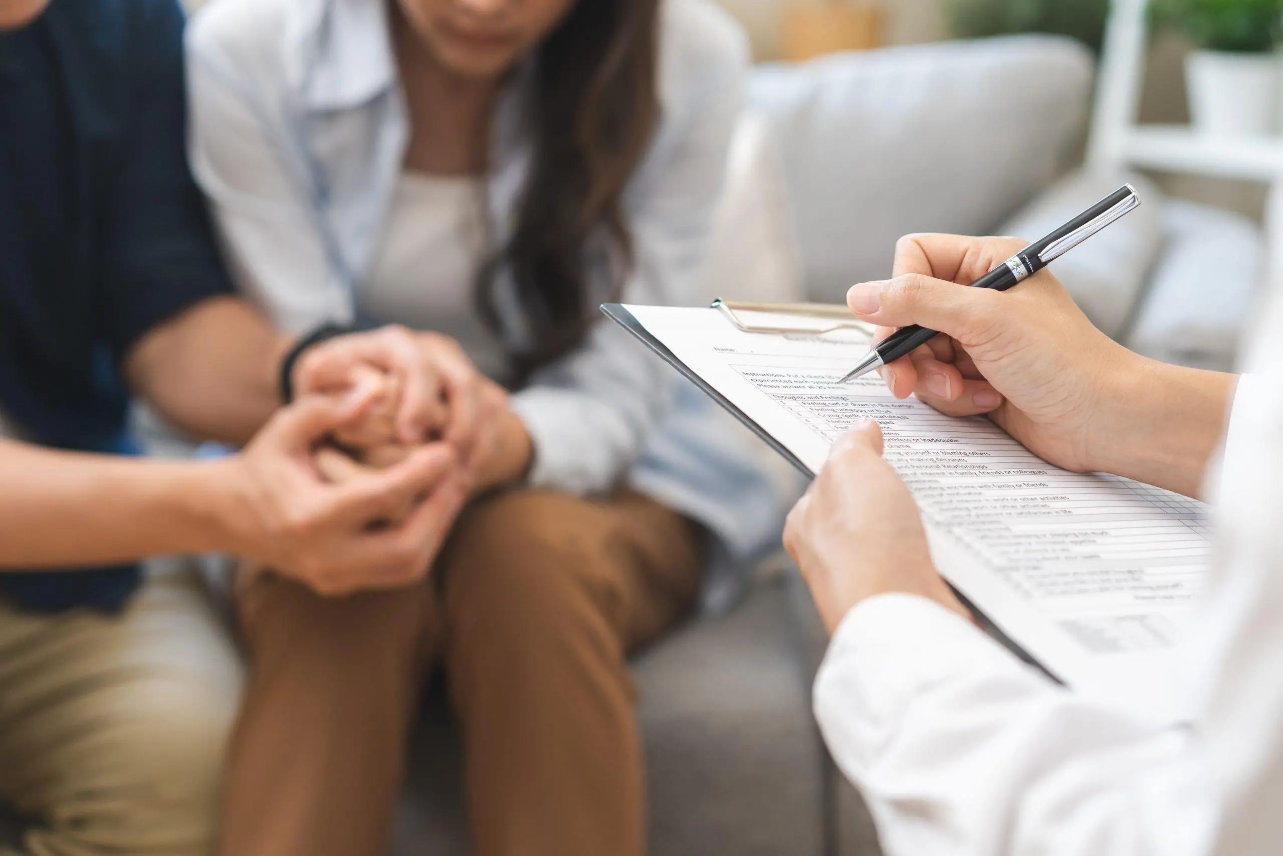 Psychology, depression asian young couple, patient consulting problem mental health with psychologist, psychiatrist at clinic together, husband encouraging by holding hand of wife, therapy health care